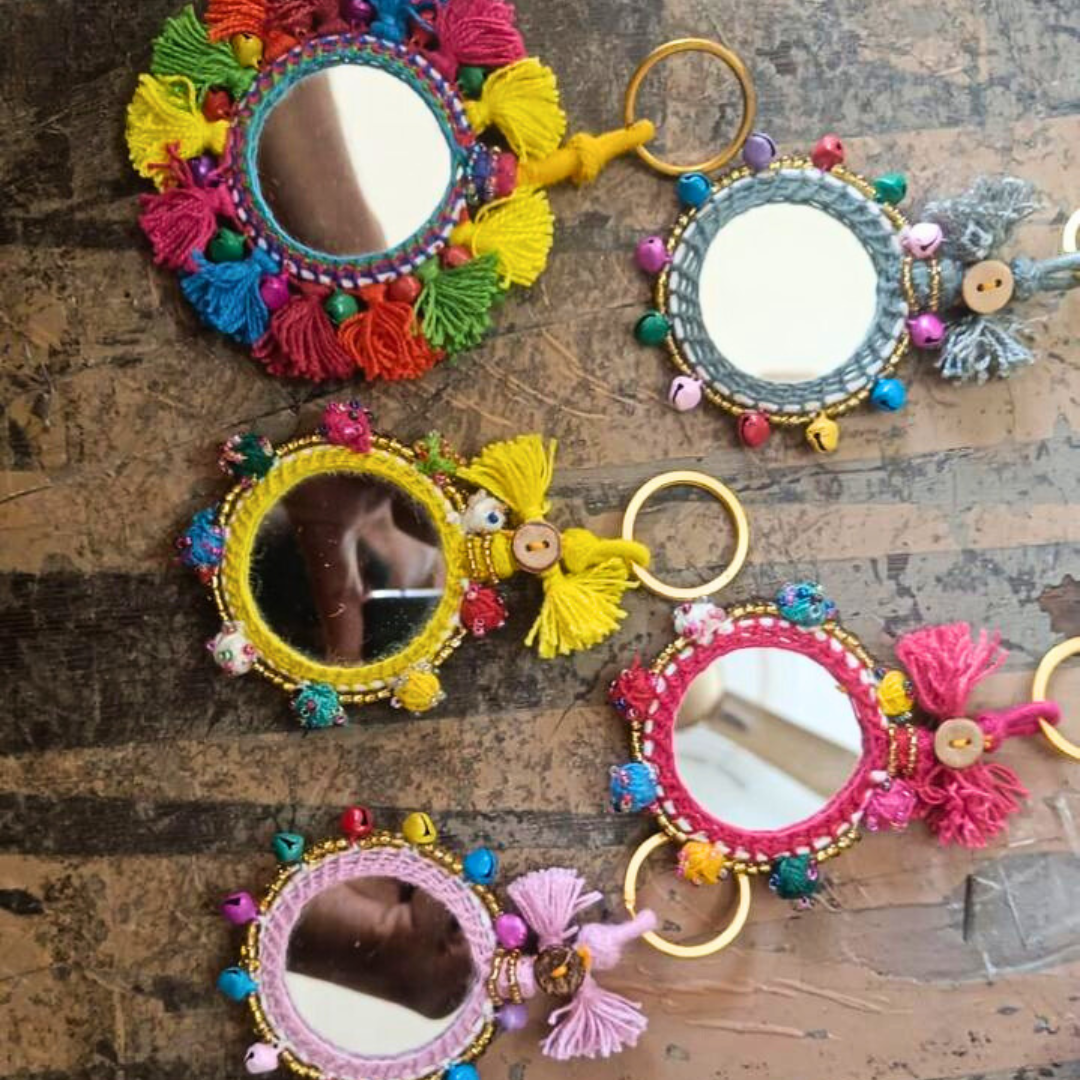 Colorful handcrafted mirror keychains with tassels