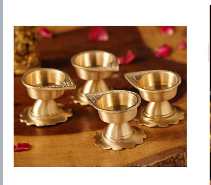 Open Festive Delight hamper displaying four brass diyas, incense, sweets and decorative packaging